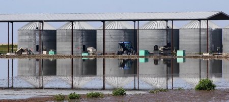 Silos are reflected in the waters of the Tulare Lake on a Monday afternoon. 